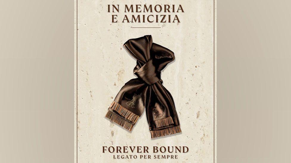 An image of a bronze coloured scarf tied in a loose knot against a cream background. Text above the scarf reads "In memoria e amicizia". Text below the image reads "Forever bound. Legato per sempre".