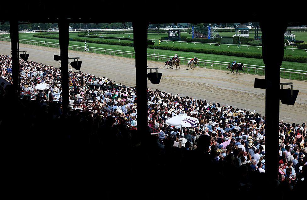 Horses head to the finish line during a race prior to the 157th running of the Belmont Stakes at Saratoga Race Course in New York. Photo by Al Bello