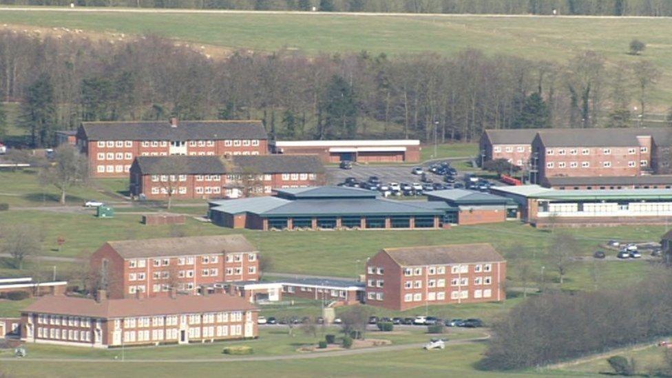 An aerial image showing the military base camp at Larkhill in Wiltshire. It is a large complex of brown brick buildings surrounded by fields and trees.