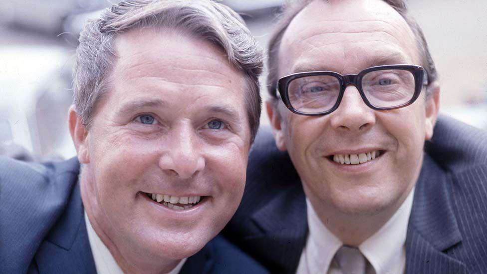 Close up of Morecambe and Wise smiling at the camera