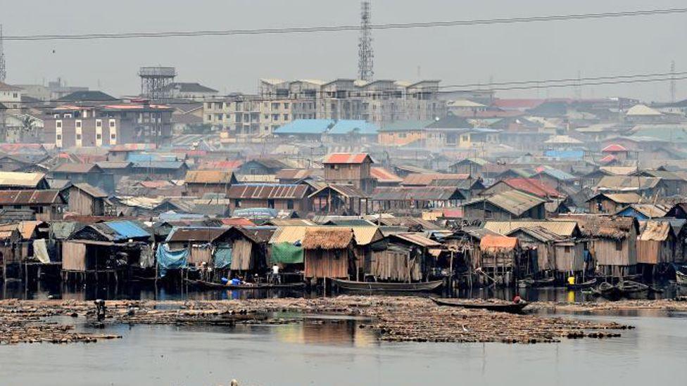 A view of the shanty Makoko community built on the lagoon in Lagos with apartment blocks being built behind.