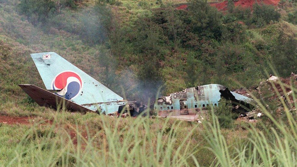 Smokes rises from the wreckage of a South Korean Air Boeing 747 at the crash site at Agana in Guam, 6 August 1997