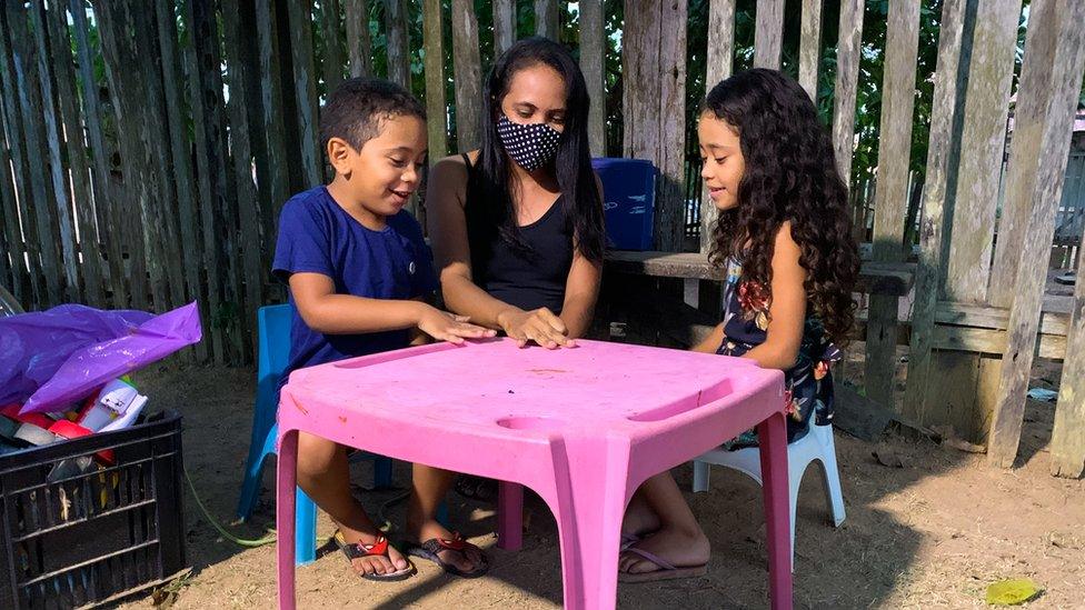 Eugenia Lima Silva, who was diagnosed with Covid-19 plays with her children