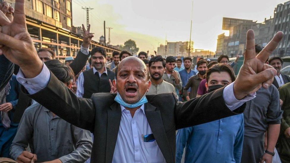 Pakistan Tehreek-e-Insaf (PTI) party activists and supporters of Pakistan's former Prime Minister Imran Khan celebrate in Peshawar after the Supreme Court acquitted Khan