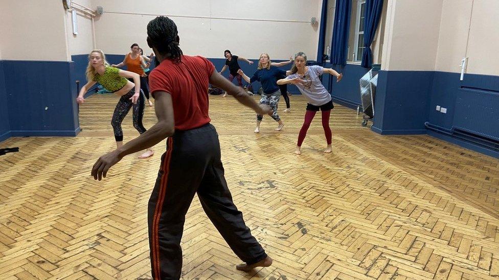 A dance troupe practising