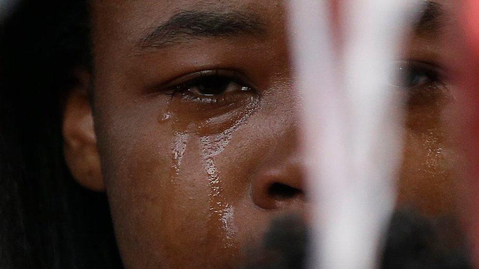 One of the family members of Sylville K. Smith attends a candlelight vigil at a site where Smith was shot and killed Saturday by Milwaukee Police