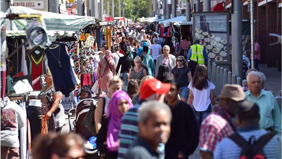 People walk through Walthamstow market