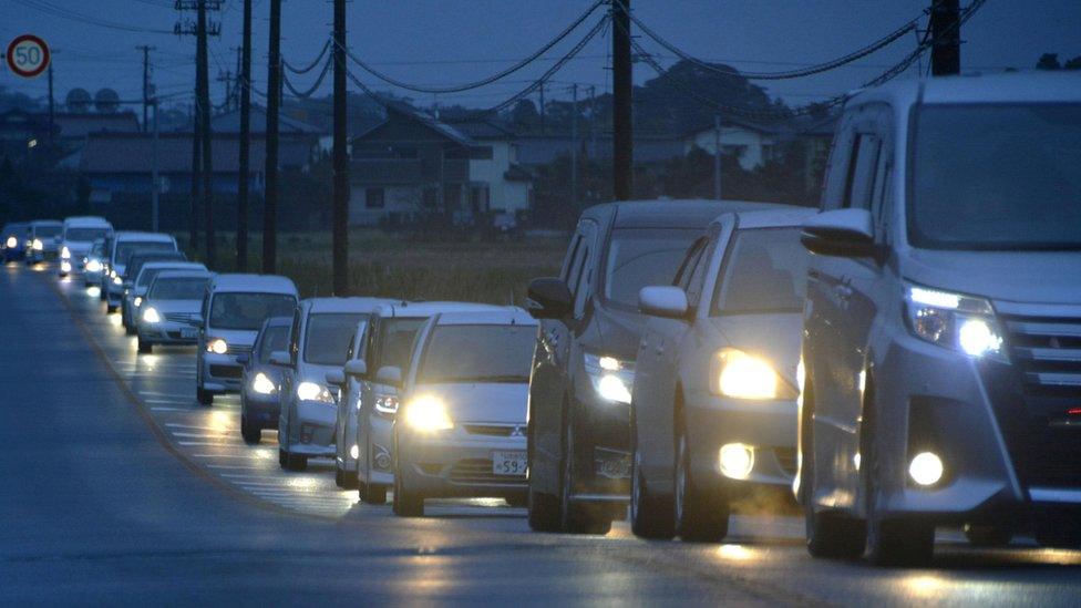 A traffic jam is seen as people evacuate after tsunami advisories were issued following an earthquake, in Iwaki