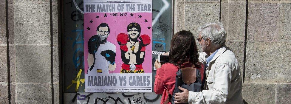 A poster showing Spanish Prime Minister Mariano Rajoy (L) and President of the Catalan Government Carles Puigdemont, on September 16, 2017 in Barcelona