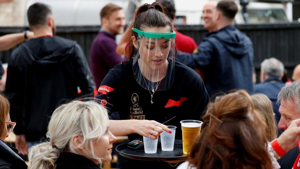 Waitress serving drinks to customers