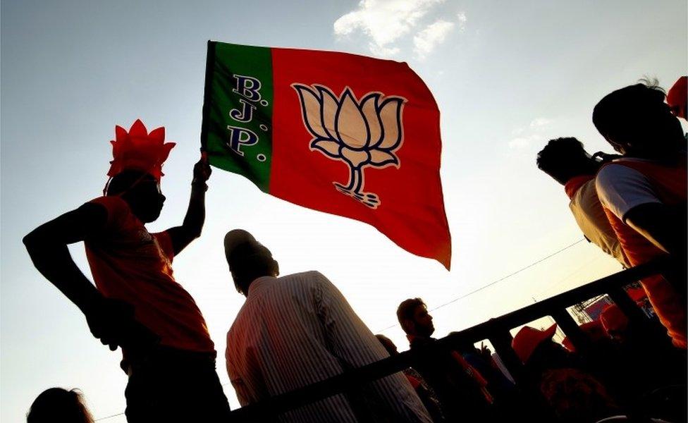 A supporters waves the party flag, during the Bharatiya Janata Party (BJP) election rally meeting in Bangalore, India, 13 April 2019