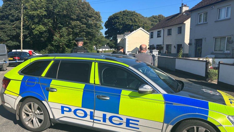 Police car and officers near a cordon in Crossmaglen