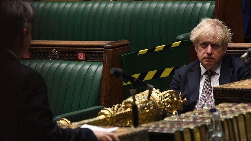 Boris Johnson sitting in the House of Commons