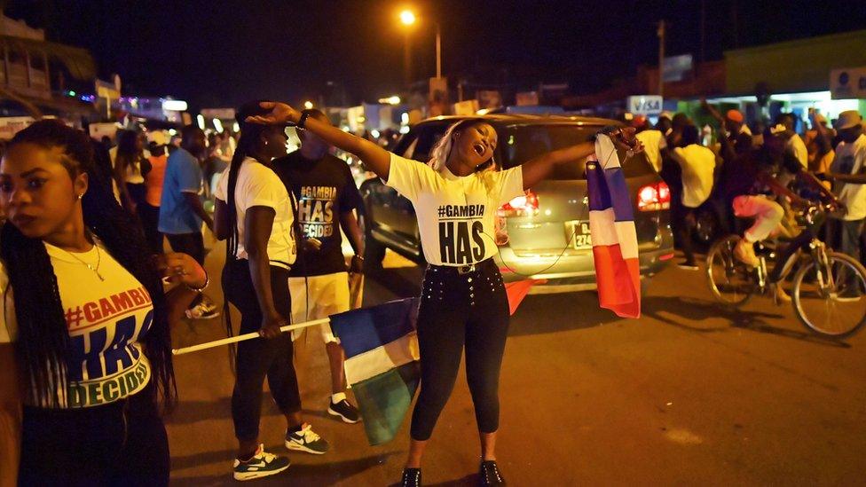 People celebrate in the streets after hearing of the confirmed departure of former Gambian leader Yahya Jammeh in Banjul on January 21, 2017