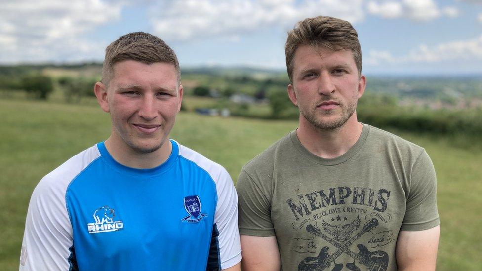 Ben and Ethan Williams standing together on a field