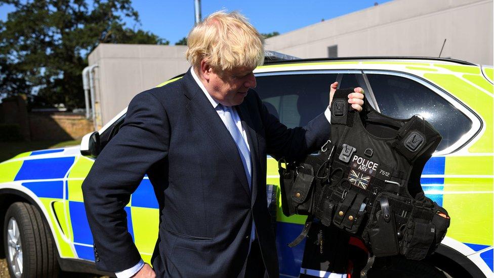 Boris Johnson examining a police vest