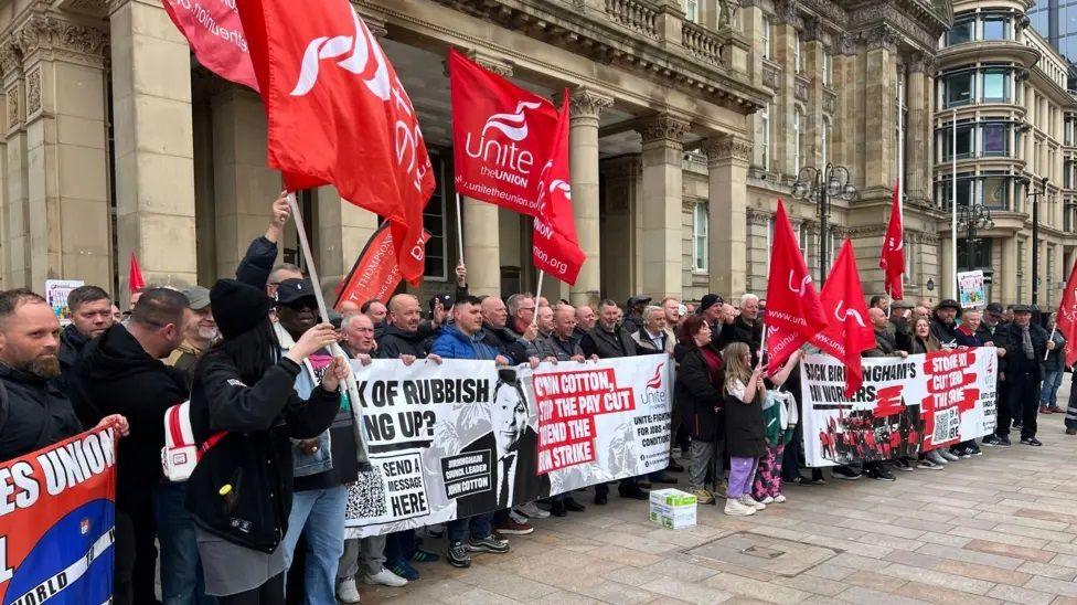 Bin workers belonging to the Unite union waved flags and held up signs 