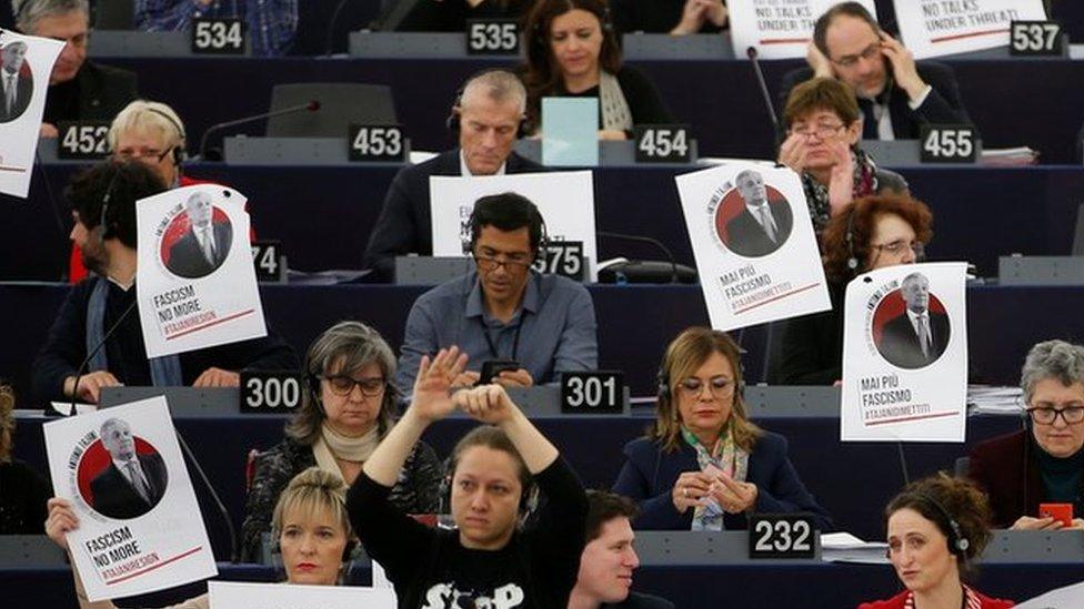 Portraits of European Parliament President Tajani with the slogan "never again fascism" are placed on the desks of a MEPs during a voting session in Strasbourg