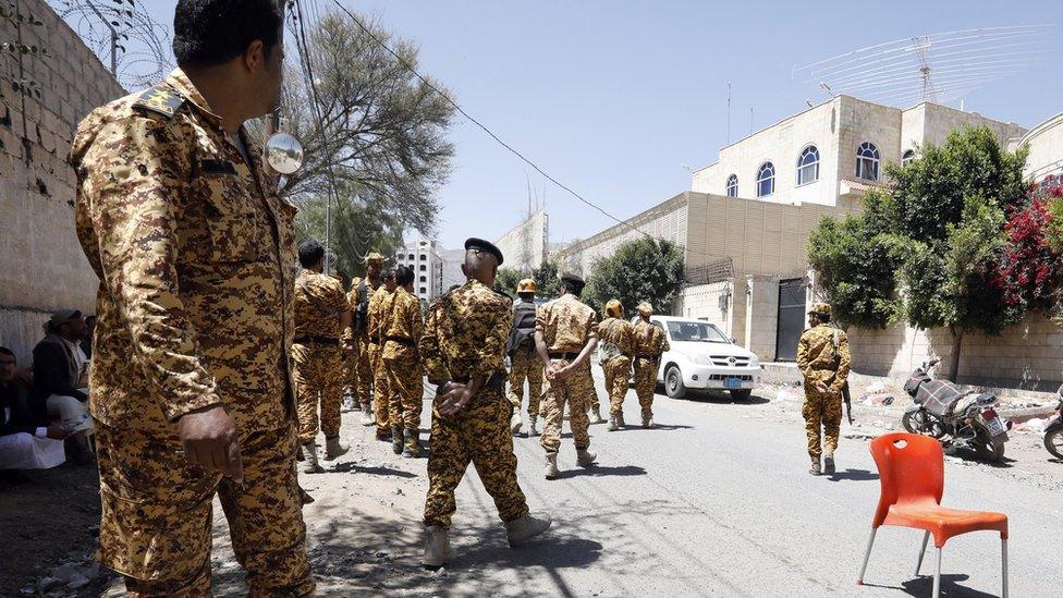 Houthi security forces outside the headquarters of the UN migration agency in Sanaa, Yemen (13 March 2021)