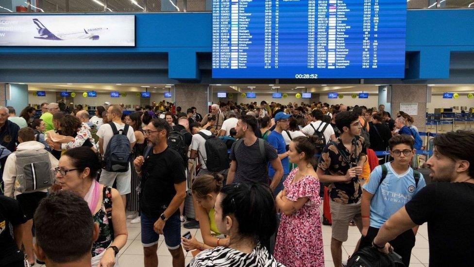 Passengers waiting to board flights away from Rhodes where there are wildfires