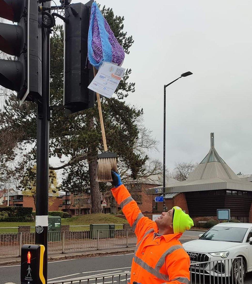 Man retrieving a postbox topper