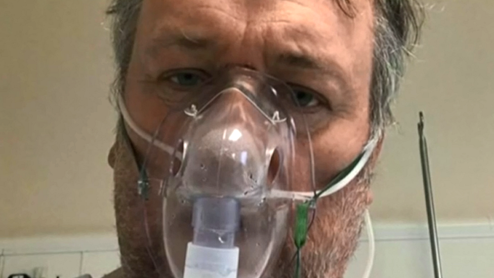 Jules Annan wearing an oxygen mask