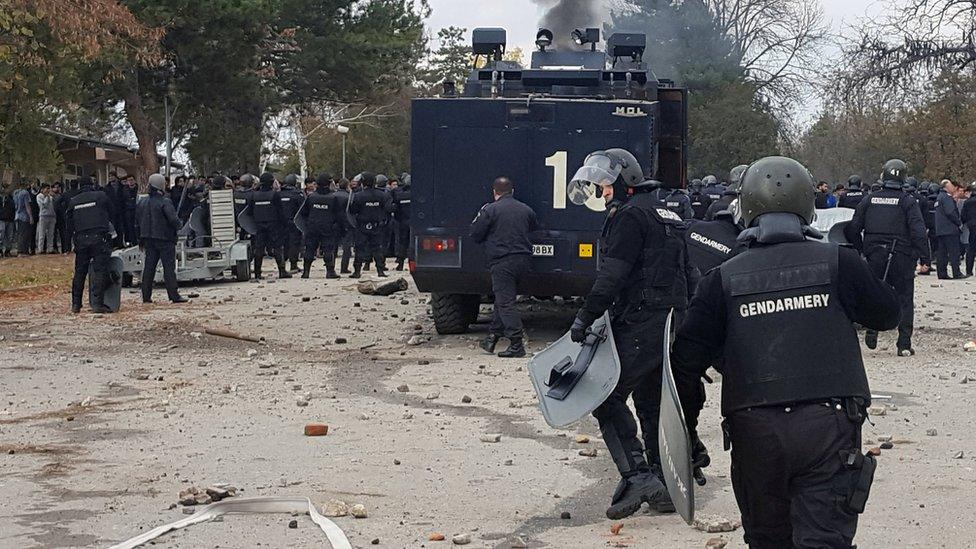 Bulgarian riot police are seen during clashes in the migrants reception centre in the town of Harmanli