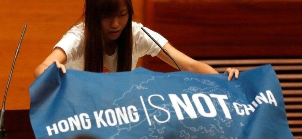 Newly elected lawmaker Yau Wai-ching displays a banner before taking oath at the Legislative Council in Hong Kong, China October 12, 2016.