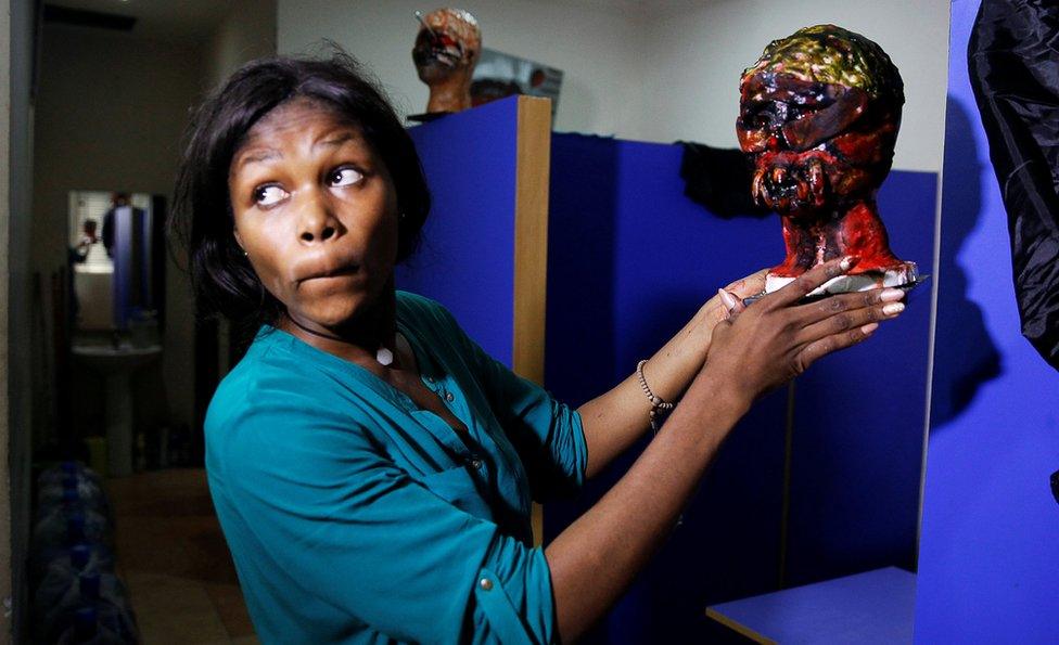 Special effects artist Abioye Balogun, 23, holds a piece of her work for a Halloween film project in her art studio in Victoria Island, Lagos, Nigeria October 28, 2016