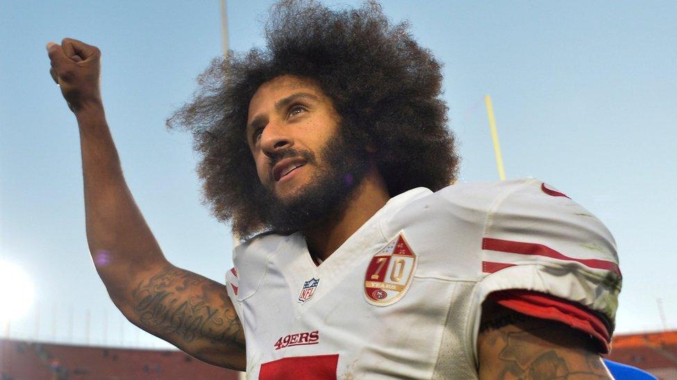 San Francisco 49ers quarterback Colin Kaepernick pumps his fist as he acknowledges cheers at Los Angeles Memorial Coliseum on December 24, 2016