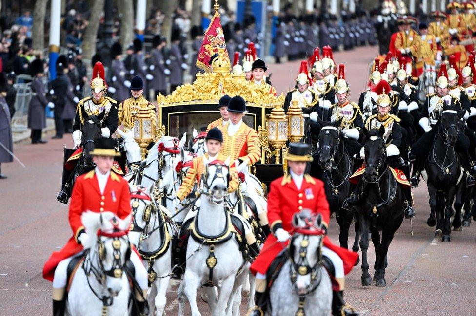 King Charles III and Queen Camilla travel along The Mall towards Buckingham Palace in the Diamond Jubilee State Coach after attending the State Opening of Parliament on November 07, 2023 in London, England.