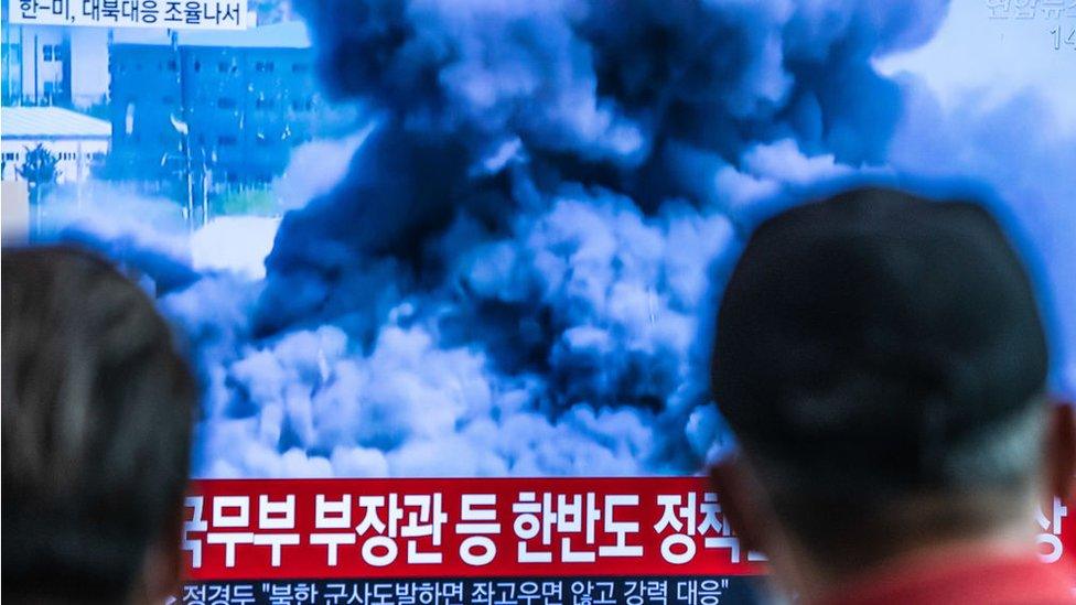 Passengers at Seoul station watch news report showing North Korea blowing up the liaison office it shared with South Korea on June 16.