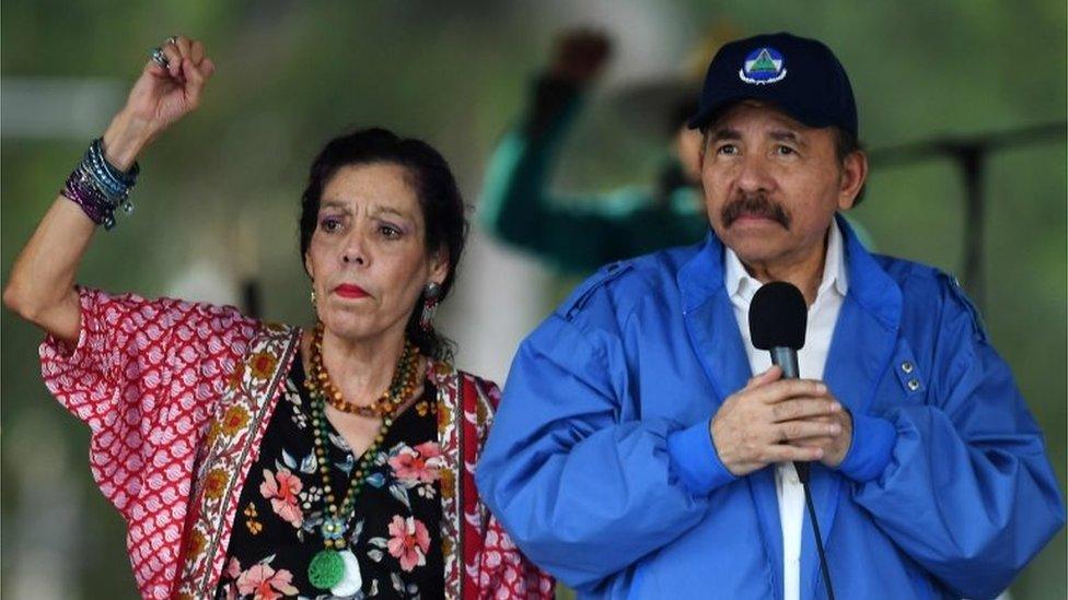 Nicaraguan President Daniel Ortega (R) and his wife, Vice President Rosario Murillo, cheer at supporters during the government-called "Walk for Security and Peace" in Managua on July 7, 2018. A