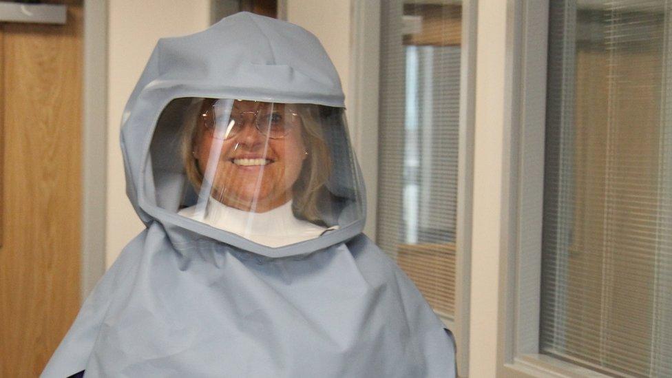 Matron Sally Young wearing the new full-face protective hood