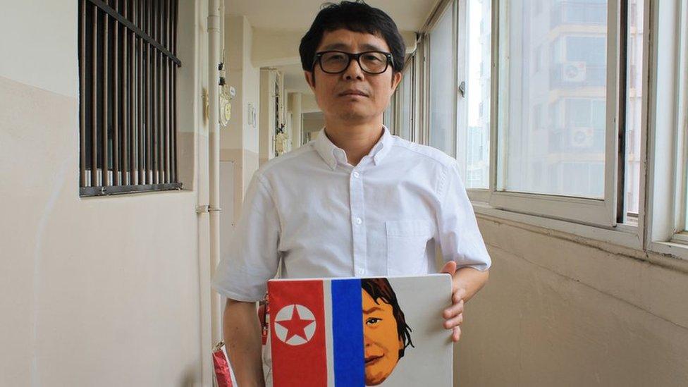 Song Byeok holds up one of his North Korean propaganda pieces