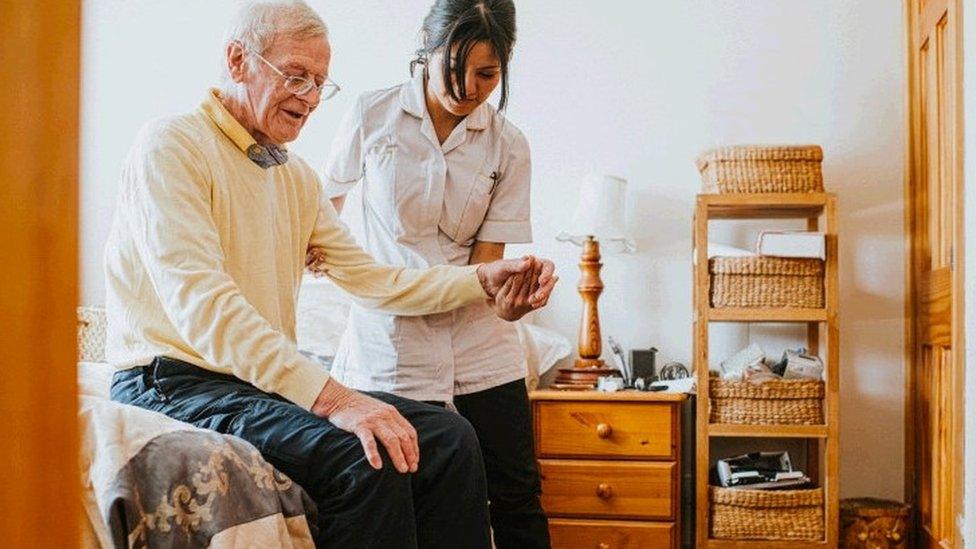 a carer helping a patient