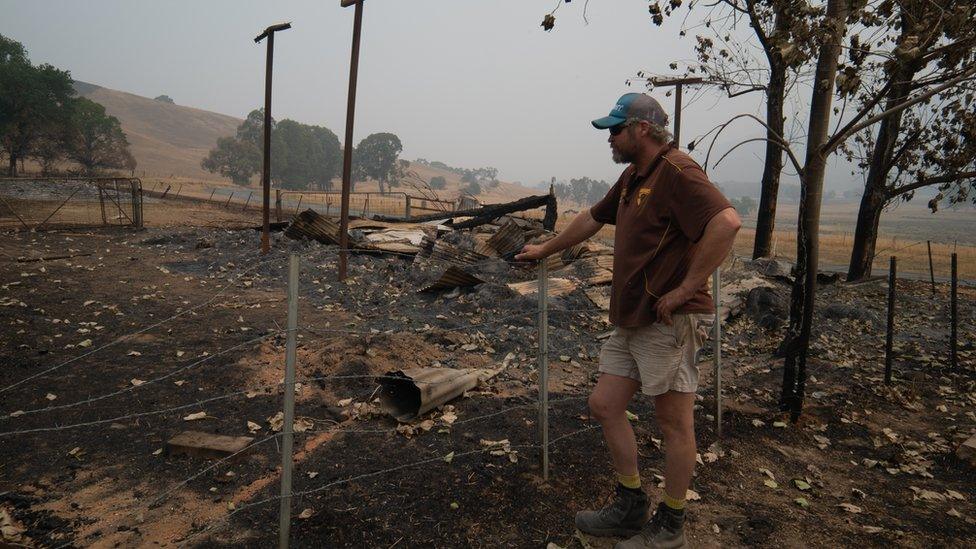 Travis assessing the damage on his farm