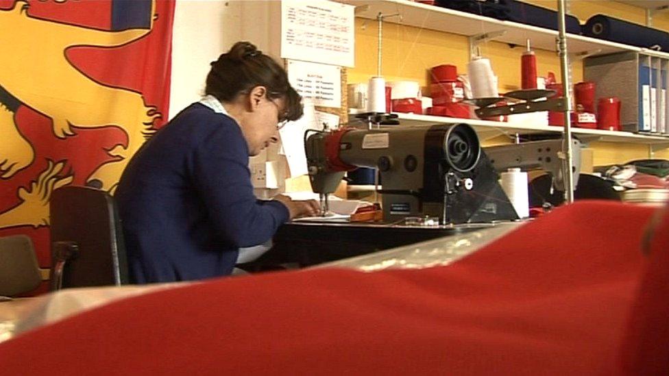 Seamstress making flag