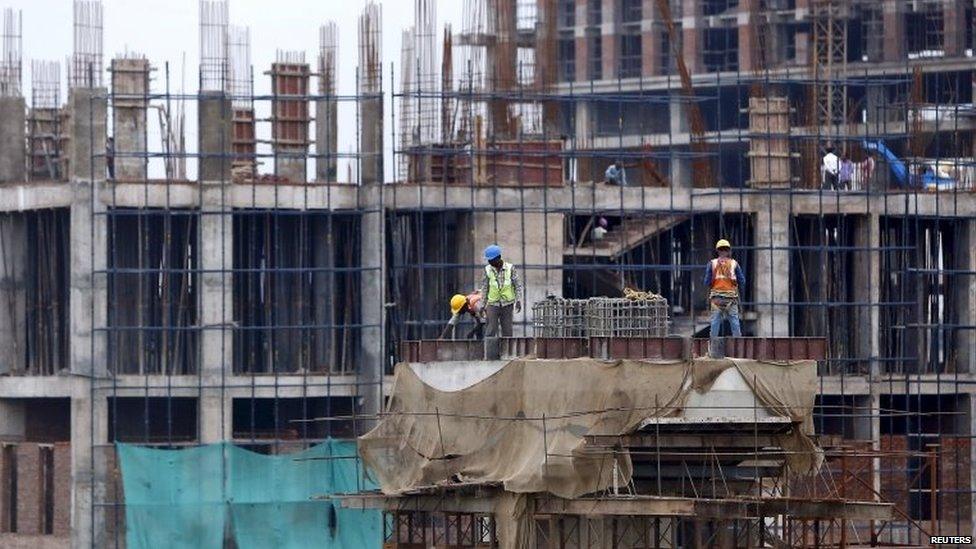 Labourers work at the construction site of a residential complex on the outskirts of New Delhi, India, June 3, 2015