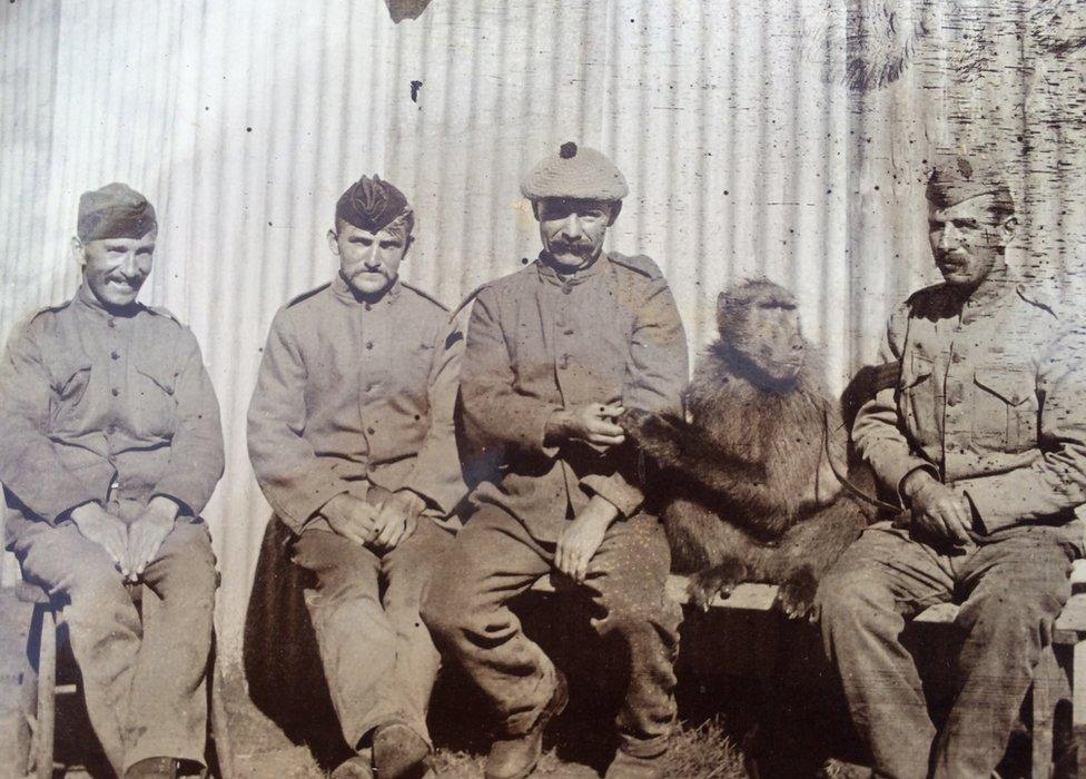 Soldiers with a baboon