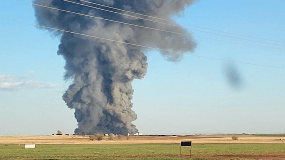 Smoke rises from the scene of South Fork Dairy near Dimmit, Texas