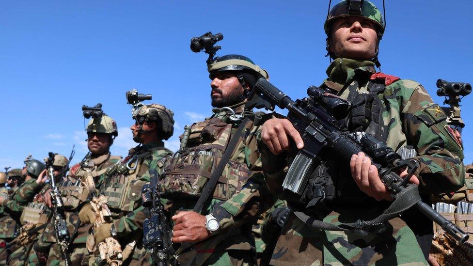 Afghan security forces attend a ceremony to show the released civilians after an operation at a Taliban private prison in Gozara district of Herat, Afghanistan, 3 March 2021