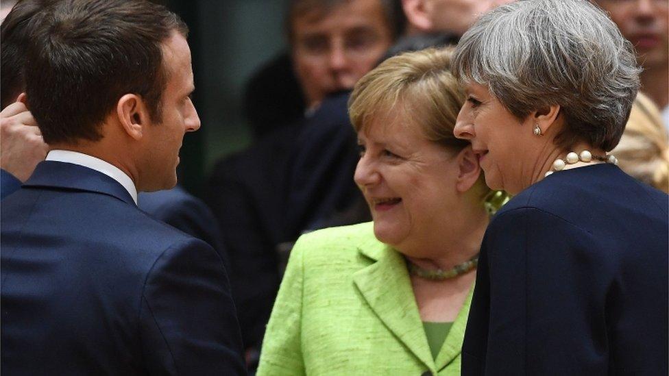 Theresa May with Angela Merkel and Emmanuel Macron at the summit