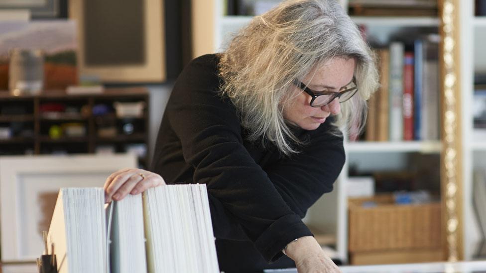 A woman works in a studio