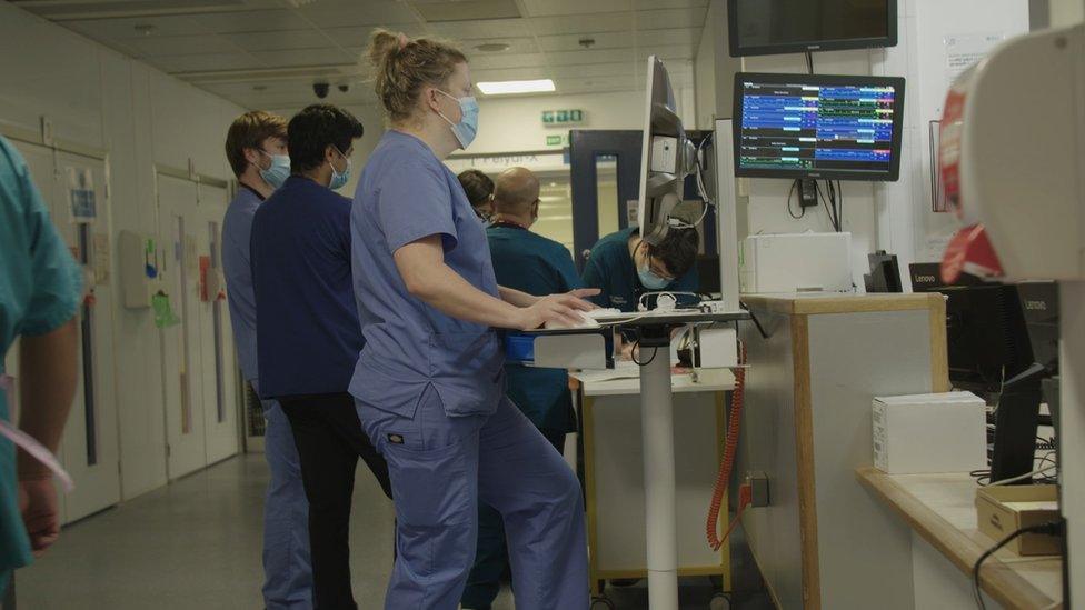 A nurse at a screen