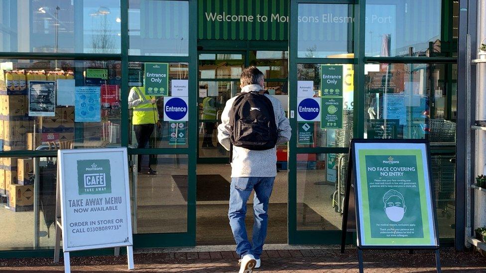 Person going into Morrisons store