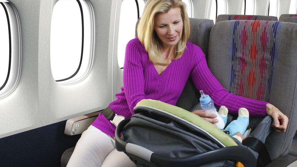 Mother and infant passenger on airplane