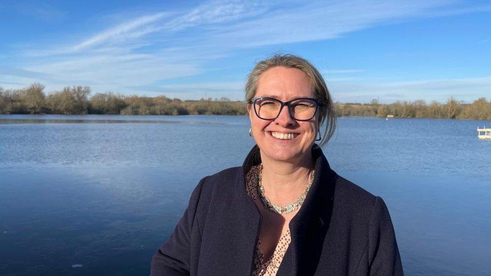 Helen Harrison standing next to a lake