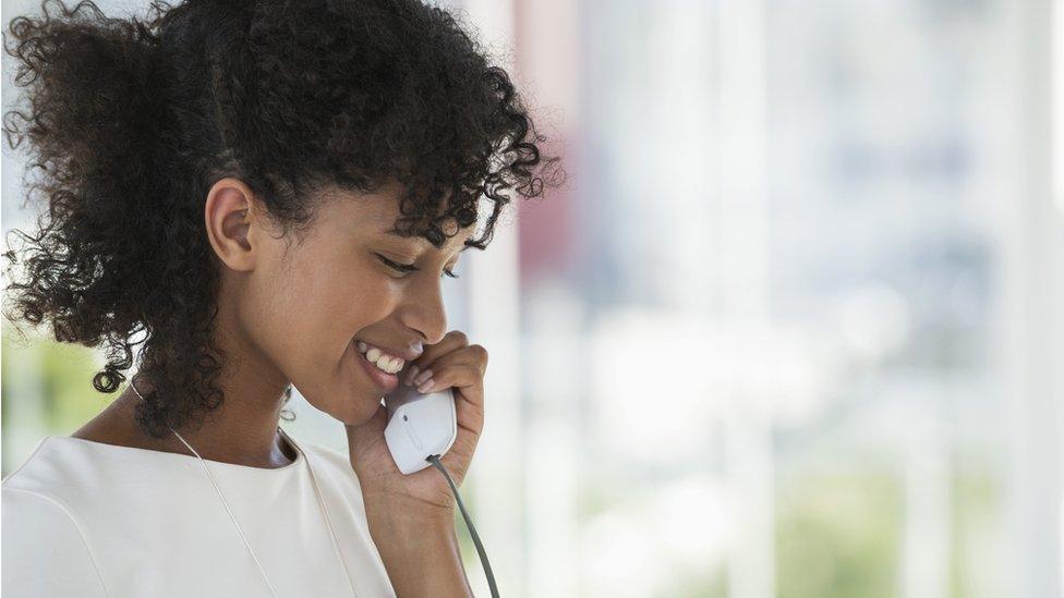 young woman on landline phone