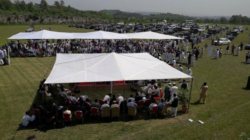 People visit an auction of government owned used cars at the premises of Prime Minister House in Islamabad, Pakistan September 17, 2018.